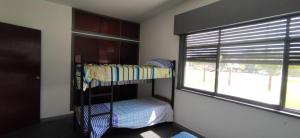 a bunk bed in a room with a window at Casa playa hermosa frente al mar in Playa Hermosa