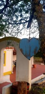 a large blue object is hanging from a tree at Sondela Self Catering in São Martinho do Porto