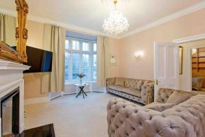 a living room with a couch and a fireplace at Beautiful 4 Bed House by Regents Park in London