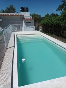 una piscina con un objeto azul frente a una casa en Casa hasta 10 personas. en Villa Rumipal