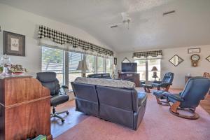 a living room with chairs and a desk and a couch at Lady Lake House with Lanai and Community Pool! in Lady Lake