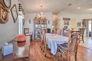 a dining room and kitchen with a table and chairs at Lady Lake House with Lanai and Community Pool! in Lady Lake