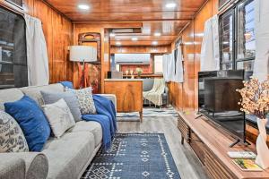 a living room with a couch and a tv at Charming Tiny Home with Private Hot Tub! in Plant City