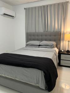 a bedroom with a large bed with a window at San Juan Home in San Juan