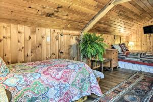 a bedroom with a bed in a room with wooden walls at Lake Champlain Vacation Rental on Private Lot in Chazy