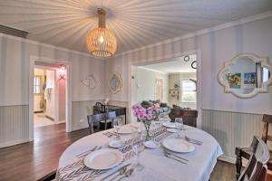 a dining room with a table with plates and flowers on it at Charming Historic Houston Home with Yard! in Houston
