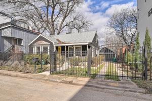 a fence in front of a house at Charming Historic Houston Home with Yard! in Houston