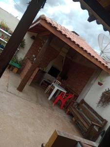 a red chair sitting outside of a house at Casa da Joci in Bonito