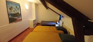 a small room with two beds in a room at Loft en duplex avec vue sur plage et chenal in Dieppe
