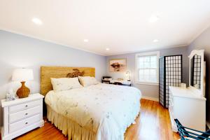 a bedroom with a large bed and a window at Chatham Living in Chatham