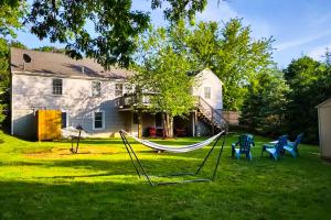a yard with a hammock in front of a house at Chatham Living in Chatham