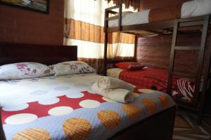 a white dog laying on a bed in a bedroom at Playita Salomon in Baños