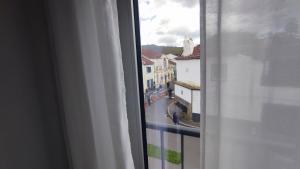 a view of a city street from a window at Atlantic 3 Bicas - Furnas in Furnas