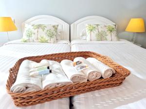 a basket filled with towels on a bed at ASPA - São Paulo Studios in Funchal