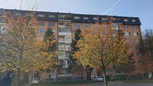 an apartment building with trees in front of it at ELEGANCE Apartment in Sarajevo