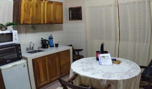 a kitchen with a table with a bottle of wine on it at Departamento centrico en Posadas, garage opcional D3 in Posadas