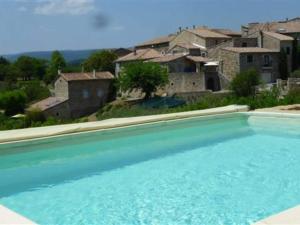 a large blue swimming pool in front of houses at Majestic holiday home in Les Assions with terrace in Les Assions
