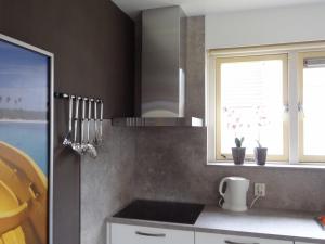 a kitchen with a sink and a window at Holiday Home in Zeeland with Garden in Wemeldinge