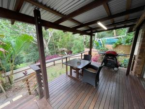 a wooden deck with a picnic table and a grill at 305A - The Artist's Cottage in Montville