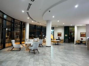 a lobby with chairs and tables in a building at Wyndham Garden North Bergen - Secaucus in North Bergen