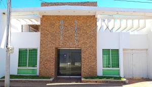 a brick building with a sign on it at HOTEL SARACHUY VALLEDUPAR in Valledupar