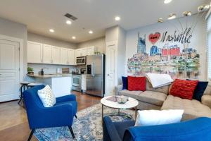 a living room with a couch and chairs and a kitchen at I luv Nash - Minutes from Broadway! in Nashville