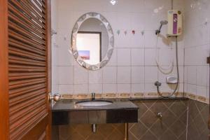 a bathroom with a sink and a mirror at We Residence in Pattaya Central