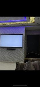 a flat screen tv on a wall in a living room at Almanar in Nador
