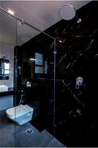 a bathroom with a toilet and a glass shower at HOTEL VINTAGE CASTLE in Coimbatore