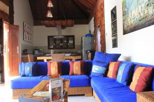 a blue couch with colorful pillows in a living room at Villa Indah 2 in Sanur