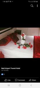 a picture of a bed with flowers on it at Nadi Airport Transit Hotel in Nadi
