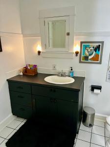 a bathroom with a sink and a mirror at Forest Park Sanctuary in Portland