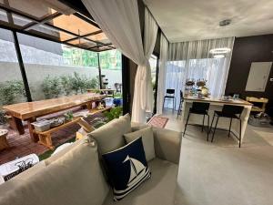 a living room with a couch and a table at Seafront OnCall - private jacuzzi with 4 cozy bedrooms in San Juan