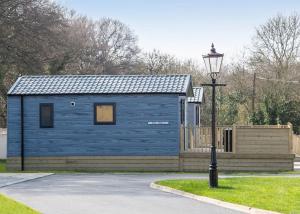 a blue shed with a street light in front of it at Arran Hills in Kilwinning