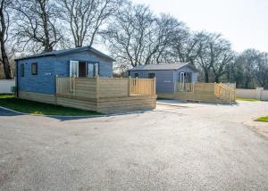 two tiny homes are parked in a lot at Arran Hills in Kilwinning