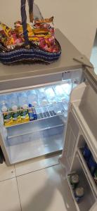 an open refrigerator filled with food and drinks at Professional HomeStay D' Alor Setar in Alor Setar