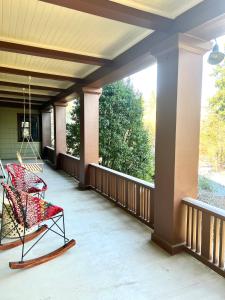 a screened porch with a chair and a large window at Forest Park Sanctuary in Portland