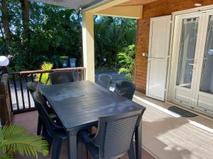 a black table and chairs on a porch at La Case Floria in Saint-André