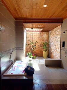 a large bathroom with a bath tub in a room at Blue Shell Resort in Mui Ne