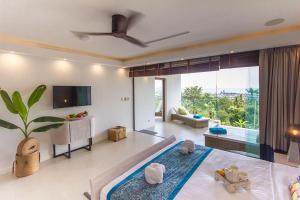 a bedroom with a bed and a living room at Stunning sea view villa Lamai Koh Samui in Lamai +20 photos