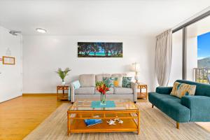 a living room with a couch and a table at Aloha Hawaii, Waikiki Condo with Great Mountain Views & Free Parking! in Honolulu