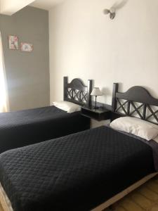 two beds in a room with two beds sidx sidx sidx sidx at Complejo Semaso in Santa Rosa