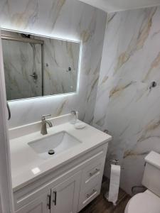 a white bathroom with a sink and a mirror at 3407 Luxury option for your visit in Orlando