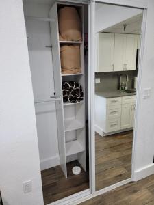 a walk in pantry with white cabinets and a glass door at 3407 Luxury option for your visit in Orlando