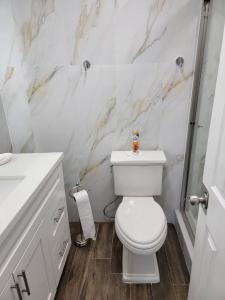 a white bathroom with a toilet and a shower at 3407 Luxury option for your visit in Orlando