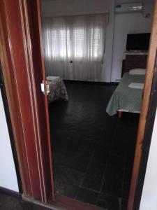 a door open to a room with a bed and a bedroom at Complejo Semaso in Santa Rosa