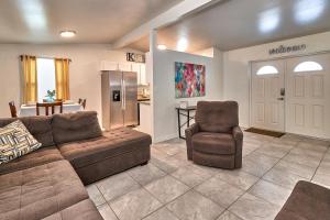 a living room with a couch and a chair and a kitchen at Convenient 4 Bedroom Home Centrally Located Tampa in Tampa
