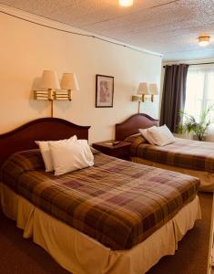 a hotel room with two beds and a window at Ledge Rock at Whiteface in Wilmington