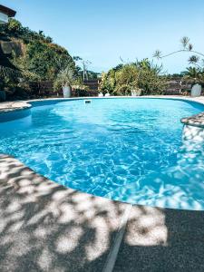 a large swimming pool with blue water at Vaikea Fare in Mahina