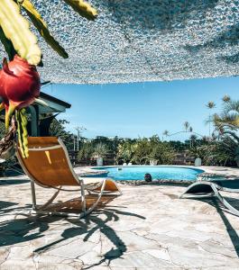 a lounge chair on a patio next to a swimming pool at Vaikea Fare in Mahina